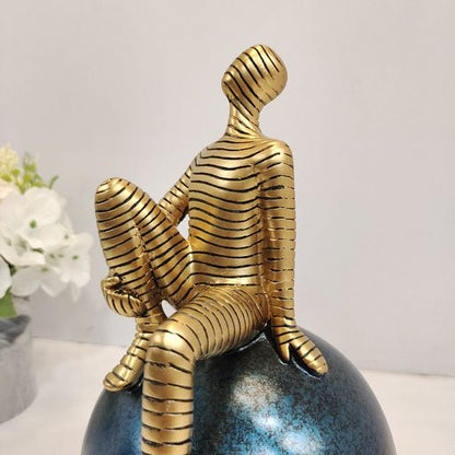 Golden abstract man on sphere Showpiece