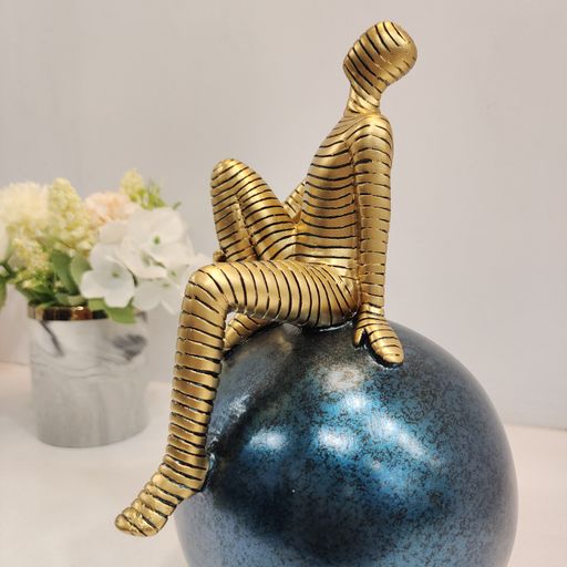 Golden abstract man on sphere Showpiece