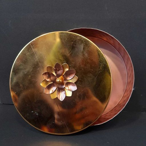 copper coated storage container with brass flower