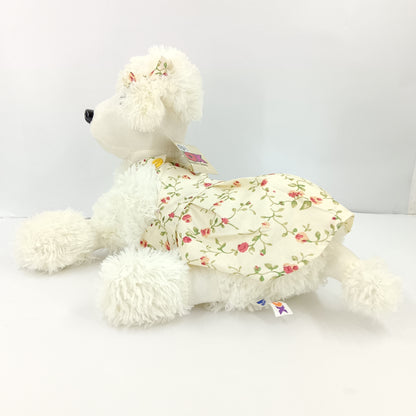 Girl dressed dog soft toy