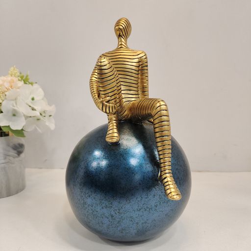 Golden abstract man on sphere Showpiece